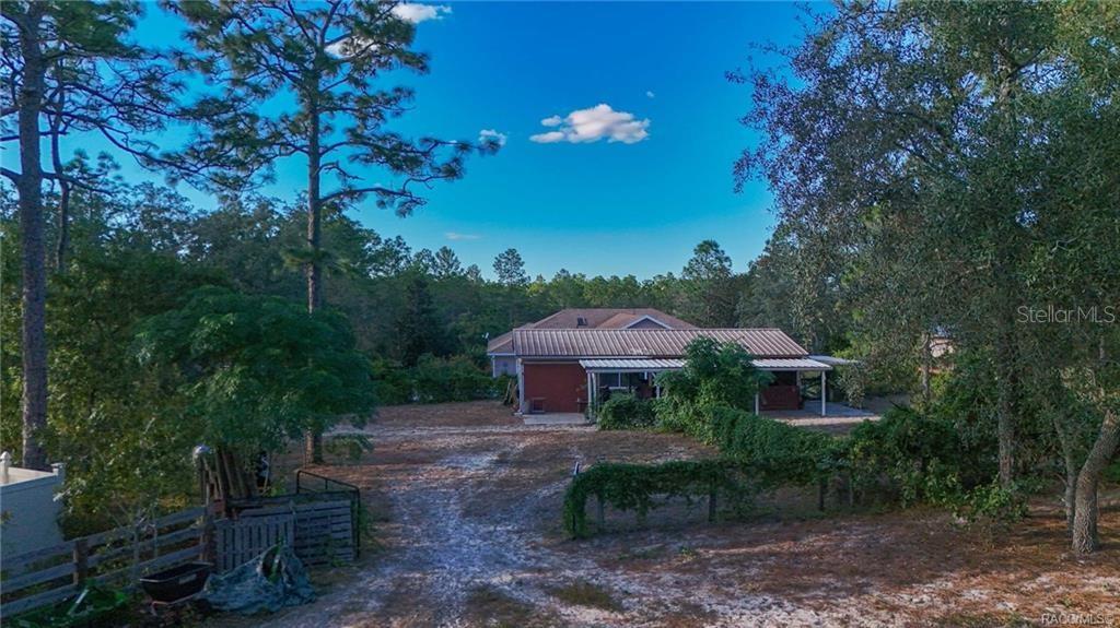 4295 North Bridge Road Beverly Hills, FL 34465 - Photo 61 of 79 a front view of a house with yard and outdoor seating