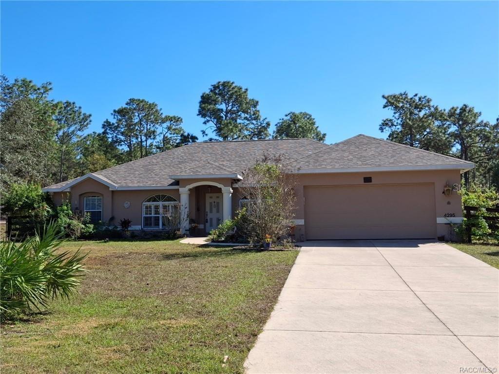 4295 North Bridge Road Beverly Hills, FL 34465 - Photo 65 of 79 a front view of house with yard and trees in the background