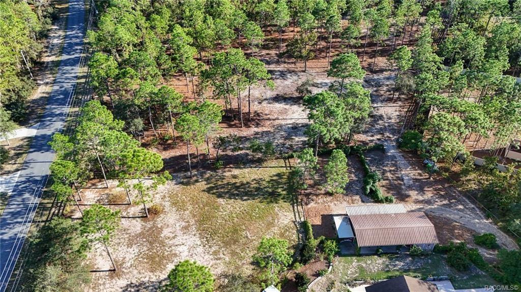 4295 North Bridge Road Beverly Hills, FL 34465 - Photo 68 of 79 an aerial view of a house with a yard and outdoor seating