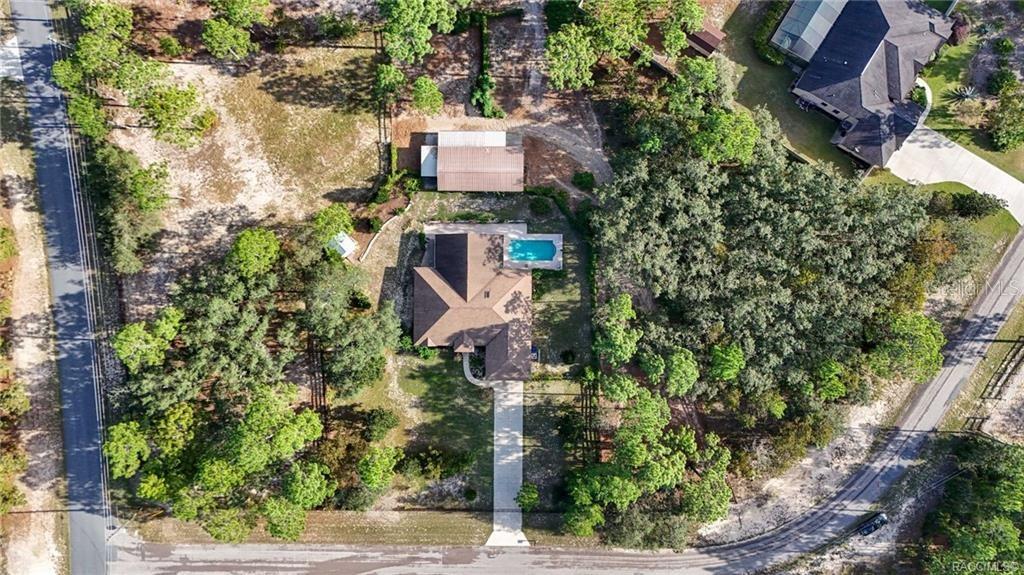 4295 North Bridge Road Beverly Hills, FL 34465 - Photo 69 of 79 an aerial view of a house with a yard and large trees
