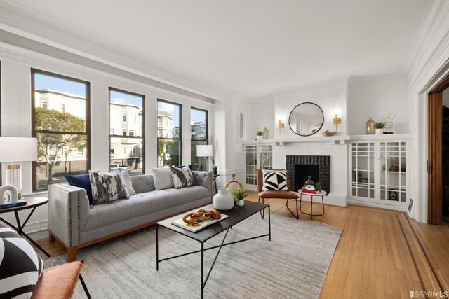 a living room with furniture and a fireplace