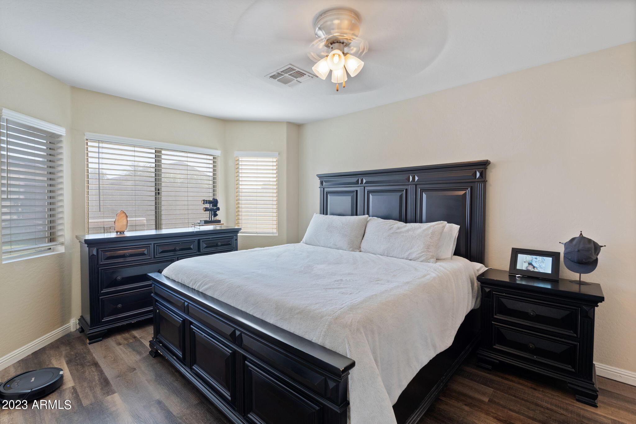 12537 West Bloomfield Road El Mirage, AZ 85335 - Photo 11 of 24 a bedroom with a bed and a chandelier