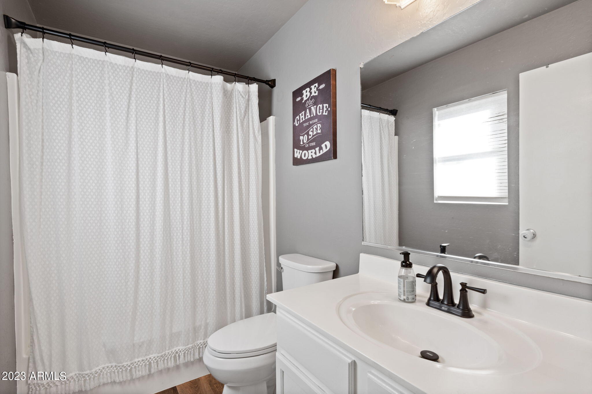 12537 West Bloomfield Road El Mirage, AZ 85335 - Photo 14 of 24 a bathroom with a sink a toilet and a mirror