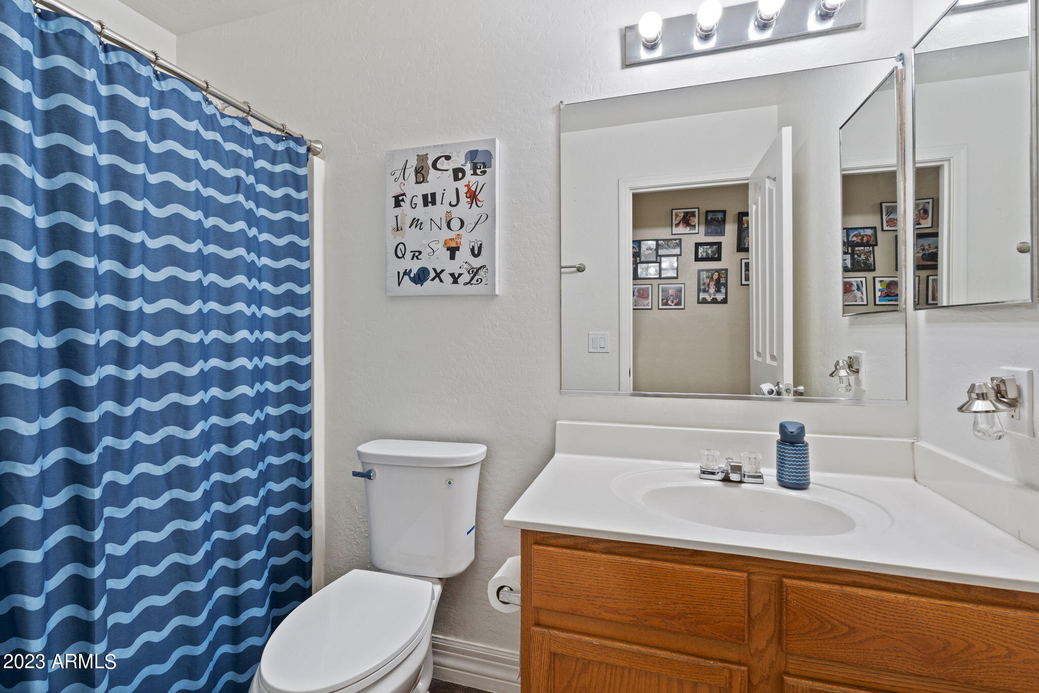 12537 West Bloomfield Road El Mirage, AZ 85335 - Photo 17 of 24 a bathroom with a toilet sink and mirror