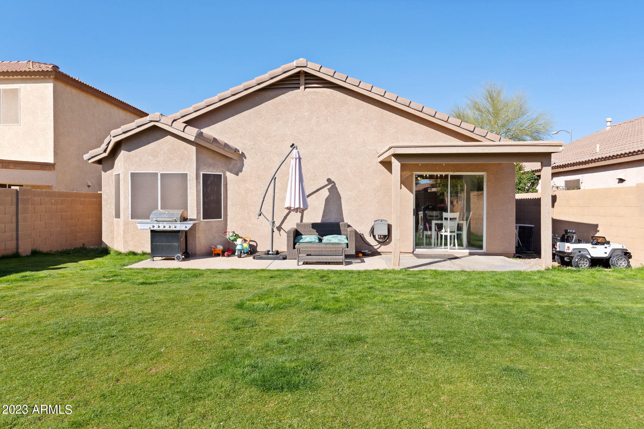 12537 West Bloomfield Road El Mirage, AZ 85335 - Photo 22 of 24 a view of a house with a big yard and large windows