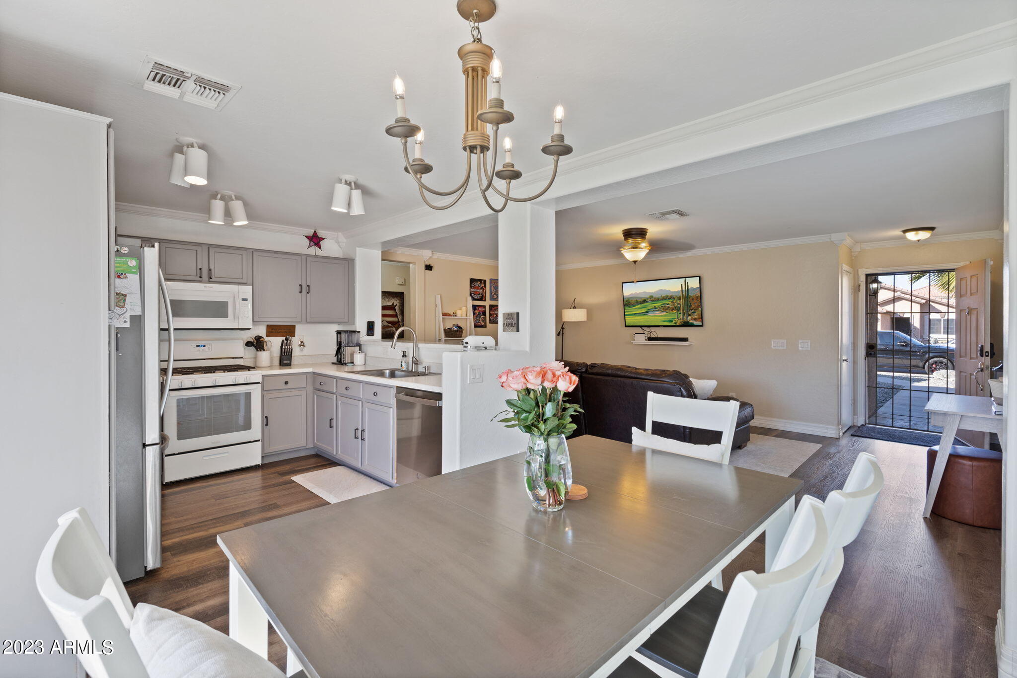 12537 West Bloomfield Road El Mirage, AZ 85335 - Photo 6 of 24 a kitchen with white cabinets stainless steel appliances and dining table