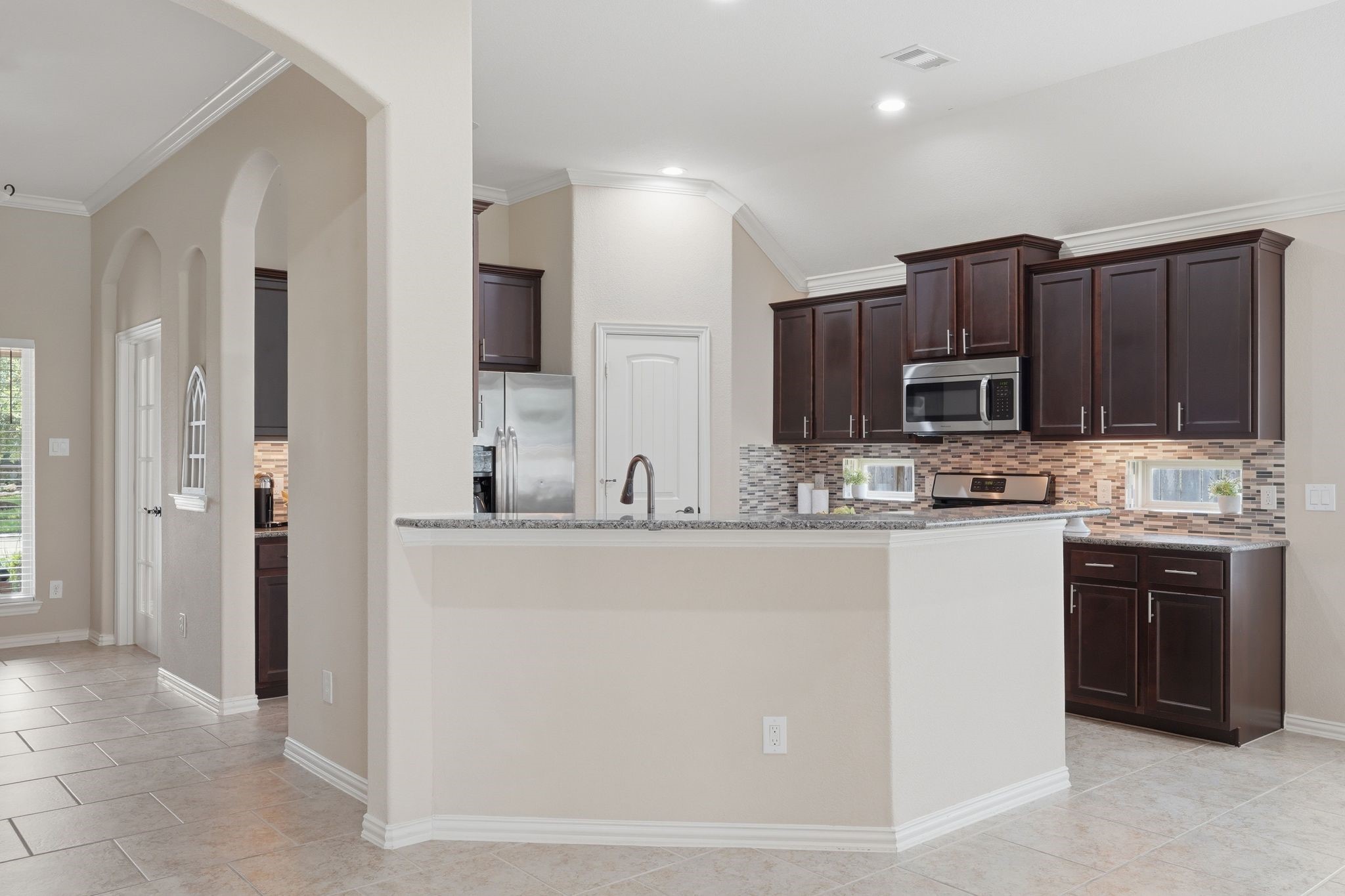 18227 Tacoma Ridge Drive Tomball, TX 77377 - Photo 13 of 45 Bright kitchen with abundant cabinetry, generous counter space, and an inviting open layout.