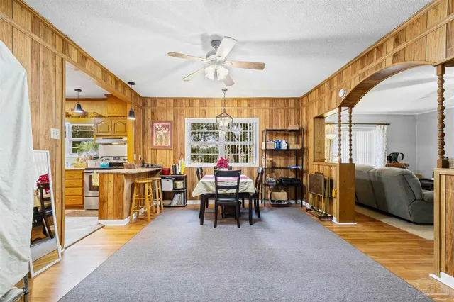 a living room with furniture a fireplace and large windows