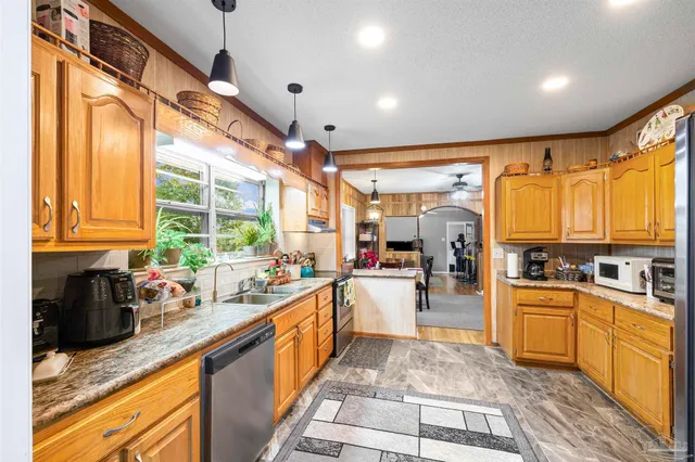 a kitchen with lots of counter top space and wooden floor