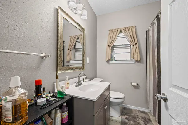 a bathroom with a toilet sink and mirror