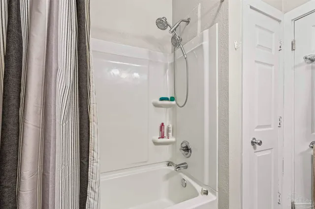 a bathroom with a shower and a sink