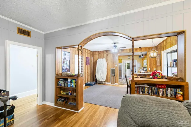 a living room with furniture fireplace and wooden floor