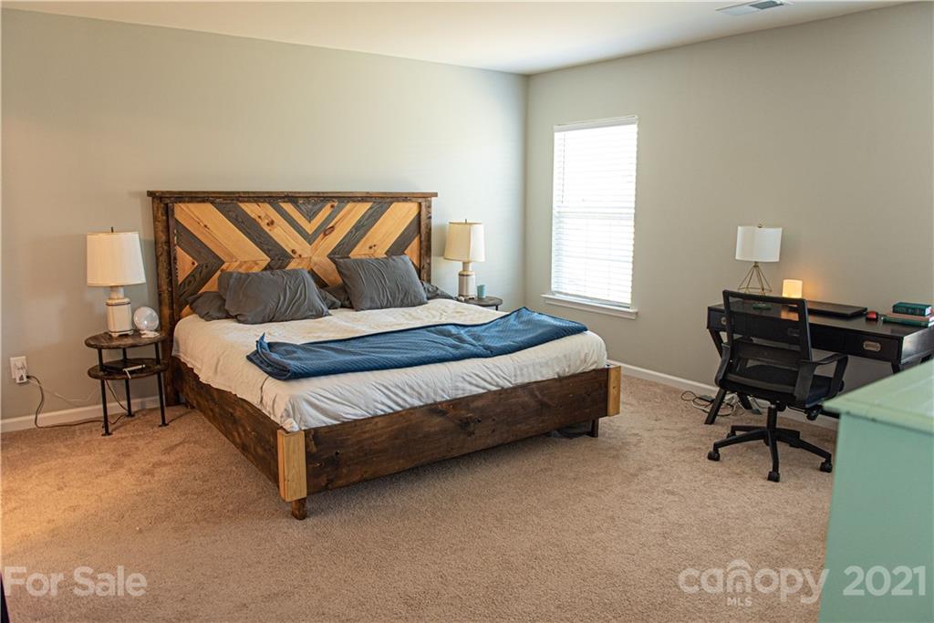 423 Triple Branch Trail Fort Mill, SC 29715 - Photo 14 of 29 a bedroom with a bed chair and a desk