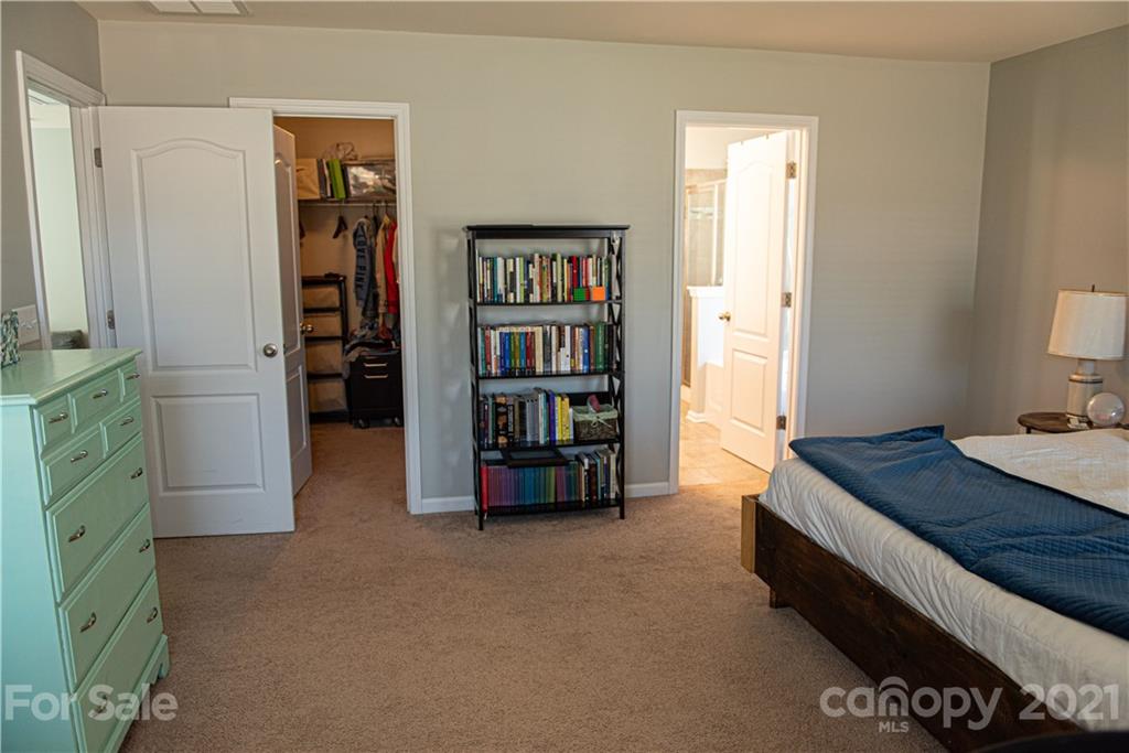 423 Triple Branch Trail Fort Mill, SC 29715 - Photo 15 of 29 a bedroom with bed and a book shelf