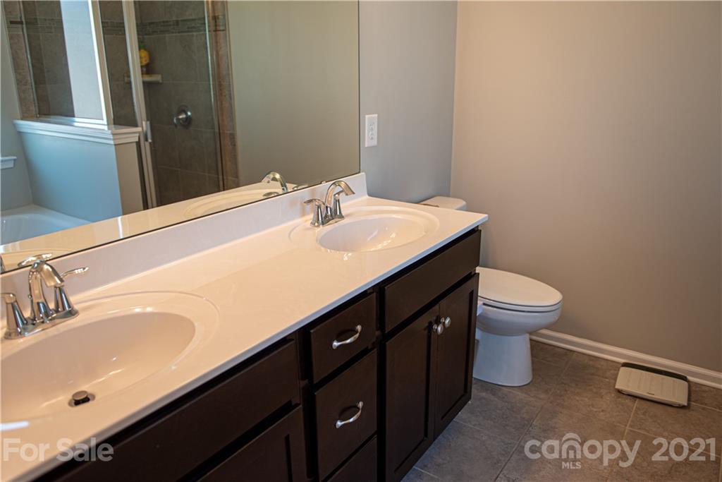 423 Triple Branch Trail Fort Mill, SC 29715 - Photo 17 of 29 a bathroom with a sink a toilet and a mirror