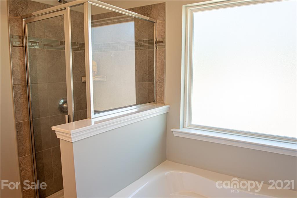 423 Triple Branch Trail Fort Mill, SC 29715 - Photo 18 of 29 a bathroom with a bathtub and a shower