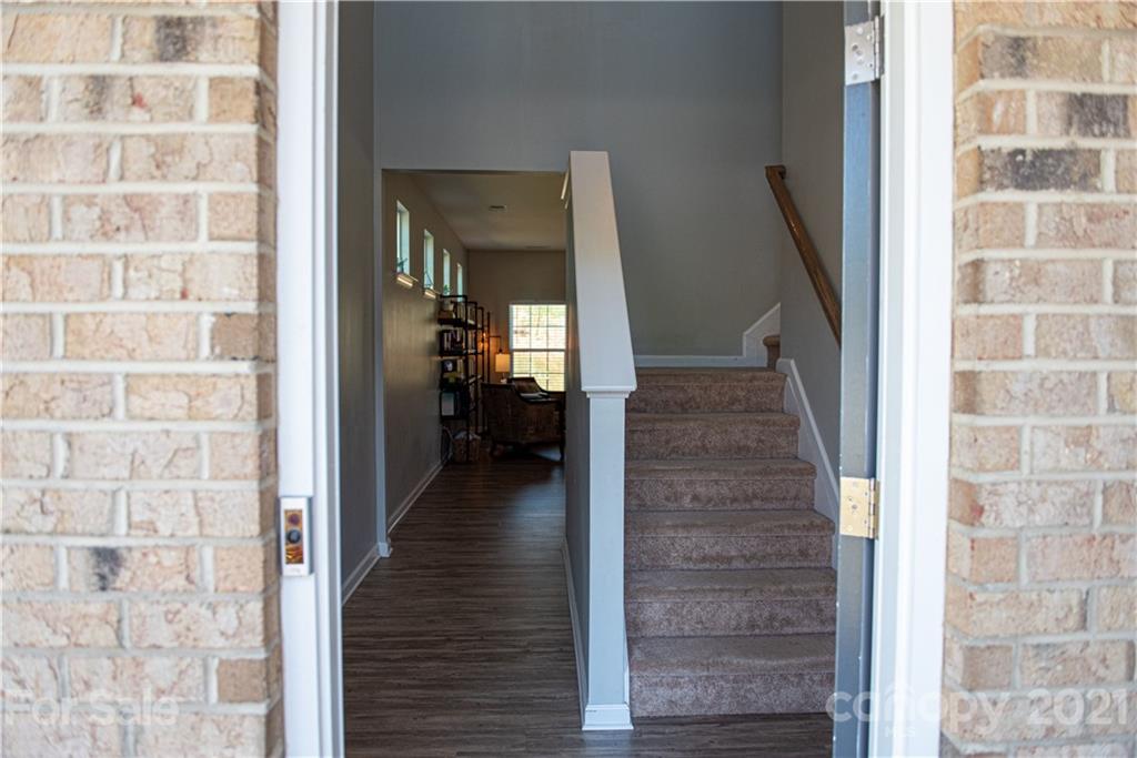 423 Triple Branch Trail Fort Mill, SC 29715 - Photo 3 of 29 a view of a hallway with wooden floor and staircase