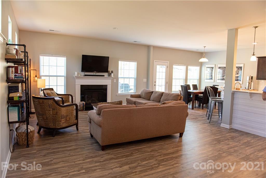 423 Triple Branch Trail Fort Mill, SC 29715 - Photo 4 of 29 a living room with furniture a fireplace and a flat screen tv