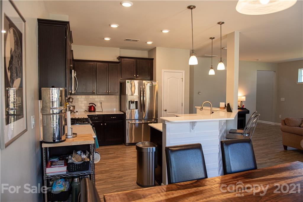 423 Triple Branch Trail Fort Mill, SC 29715 - Photo 7 of 29 a kitchen with refrigerator and chairs