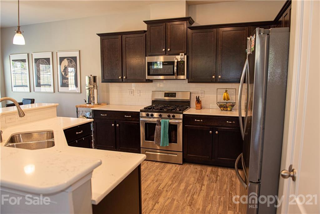 423 Triple Branch Trail Fort Mill, SC 29715 - Photo 10 of 29 a kitchen with stainless steel appliances a stove a sink and a refrigerator