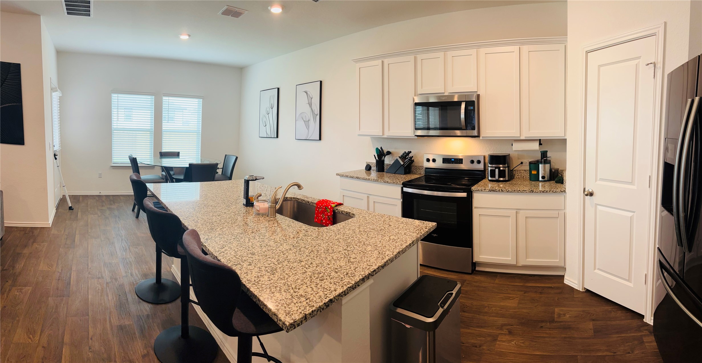 14817 Perlino Way, Unit A Manor, TX 78653 - Photo 7 of 40 a kitchen with a stove a sink and a refrigerator