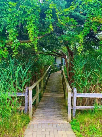 a balcony with wooden floor and stairs