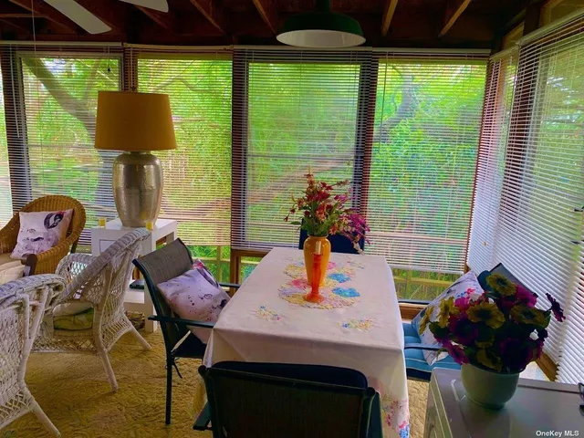 a dining room with furniture and a window