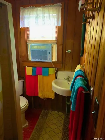 a backyard of a house with lots of green space and glass windows