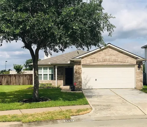 a view of a garage with a tree