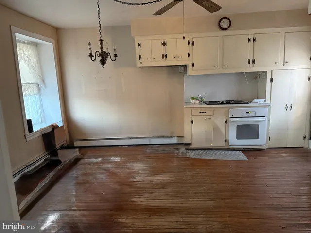 a view of a kitchen with stove cabinets and wooden floor