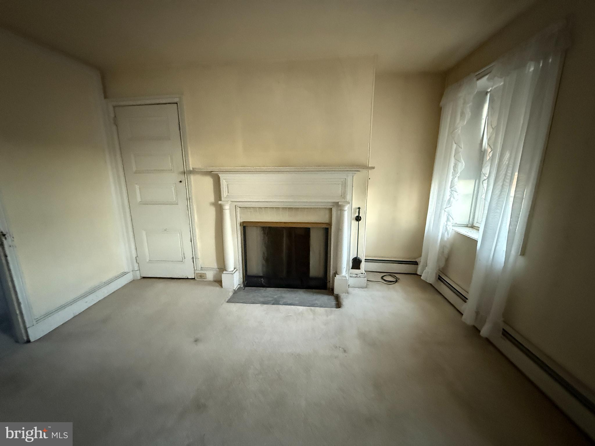 281 Matsonford Road Conshohocken, PA 19428 - Photo 15 of 16 an empty room with windows and fireplace