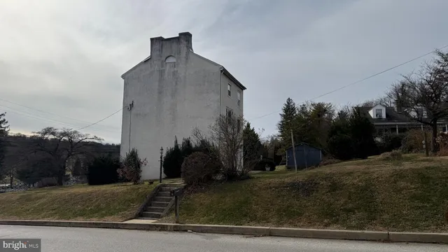 a front view of a house with trees