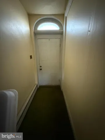 a view of a small space with wooden floor and a potted plant