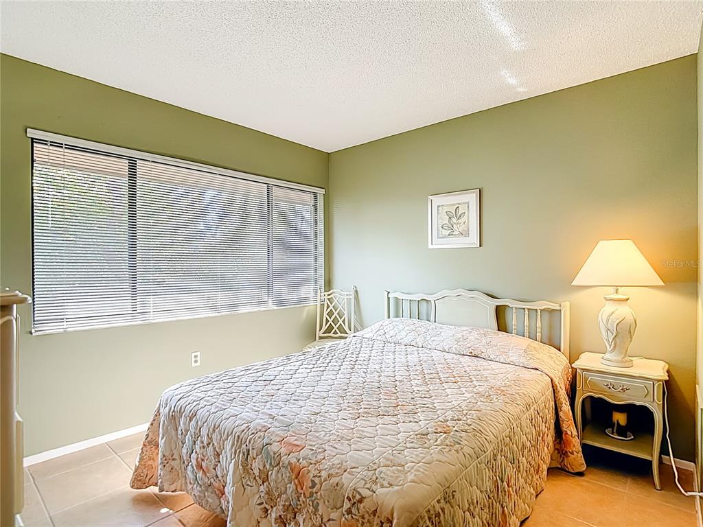 12924 Wedgewood Way, Unit D Hudson, FL 34667 - Photo 28 of 69 a bedroom with a bed and a window