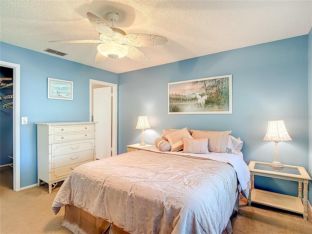 12924 Wedgewood Way, Unit D Hudson, FL 34667 - Photo 36 of 69 a bedroom with a bed and a chandelier