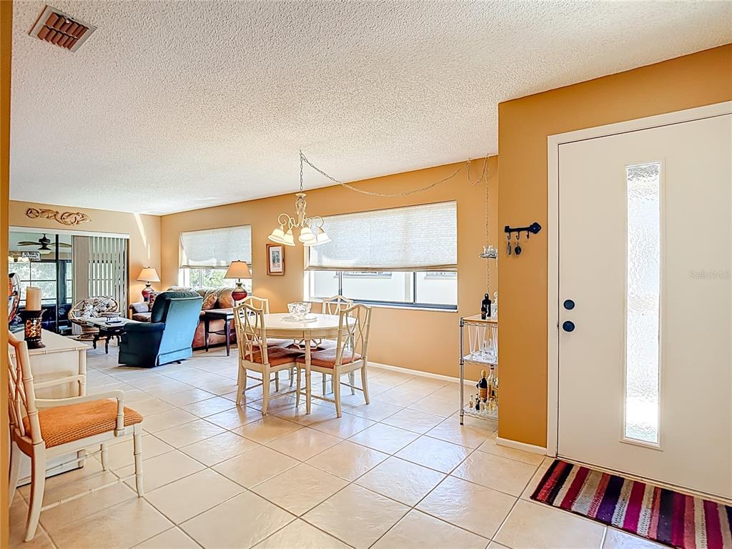 12924 Wedgewood Way, Unit D Hudson, FL 34667 - Photo 9 of 69 a living room with furniture and a dining table with rug