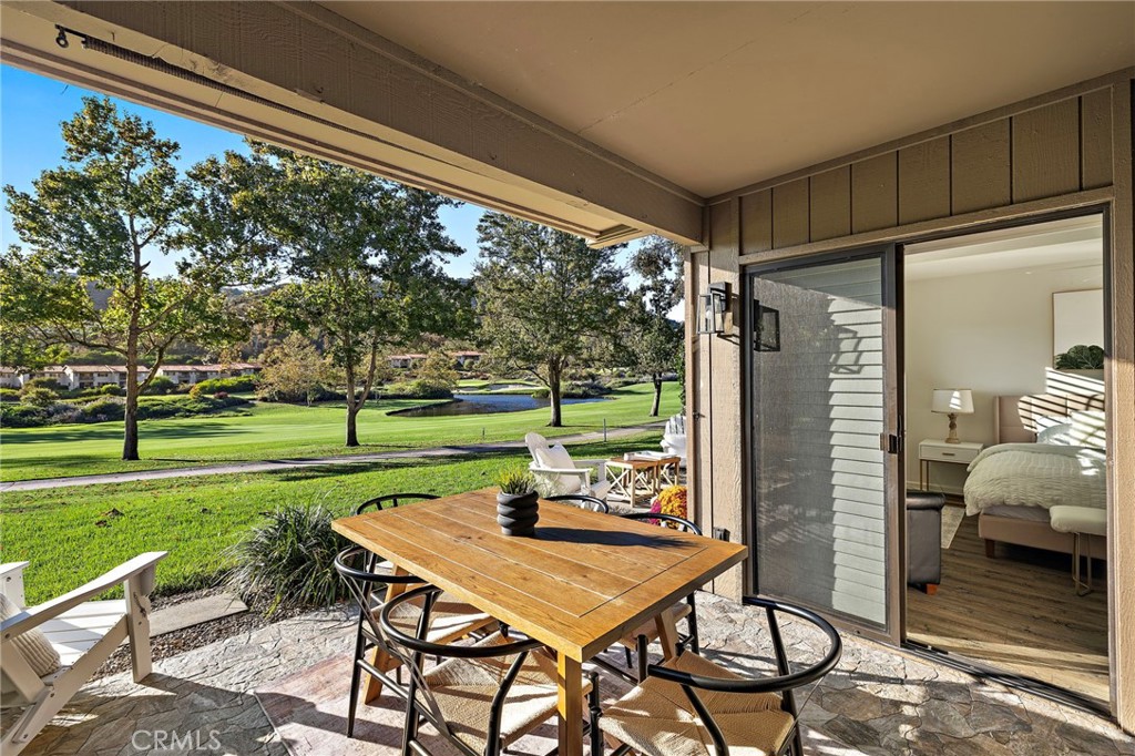 31421 East Nine Drive, Unit 79A Laguna Niguel, CA 92677 - Photo 13 of 31 a view of a patio with a table chairs and a backyard