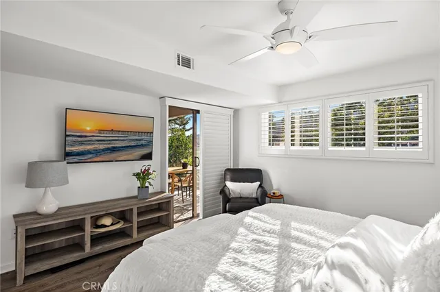 a bedroom with furniture and a flat screen tv