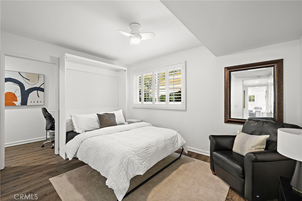 31421 East Nine Drive, Unit 79A Laguna Niguel, CA 92677 - Photo 20 of 31 a bedroom with a bed wooden floor and lamp