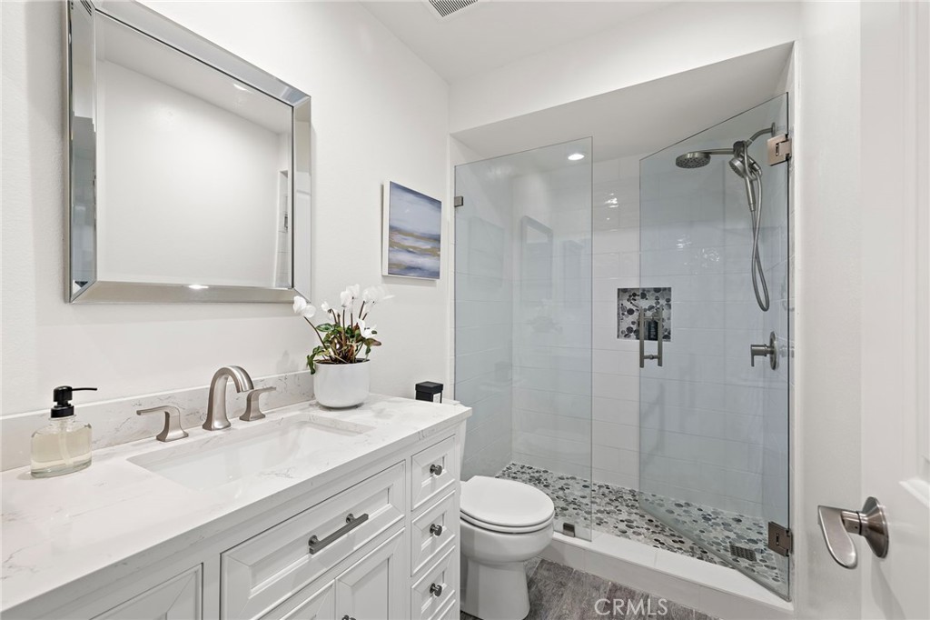 31421 East Nine Drive, Unit 79A Laguna Niguel, CA 92677 - Photo 21 of 31 a bathroom with a sink toilet a shower and a mirror