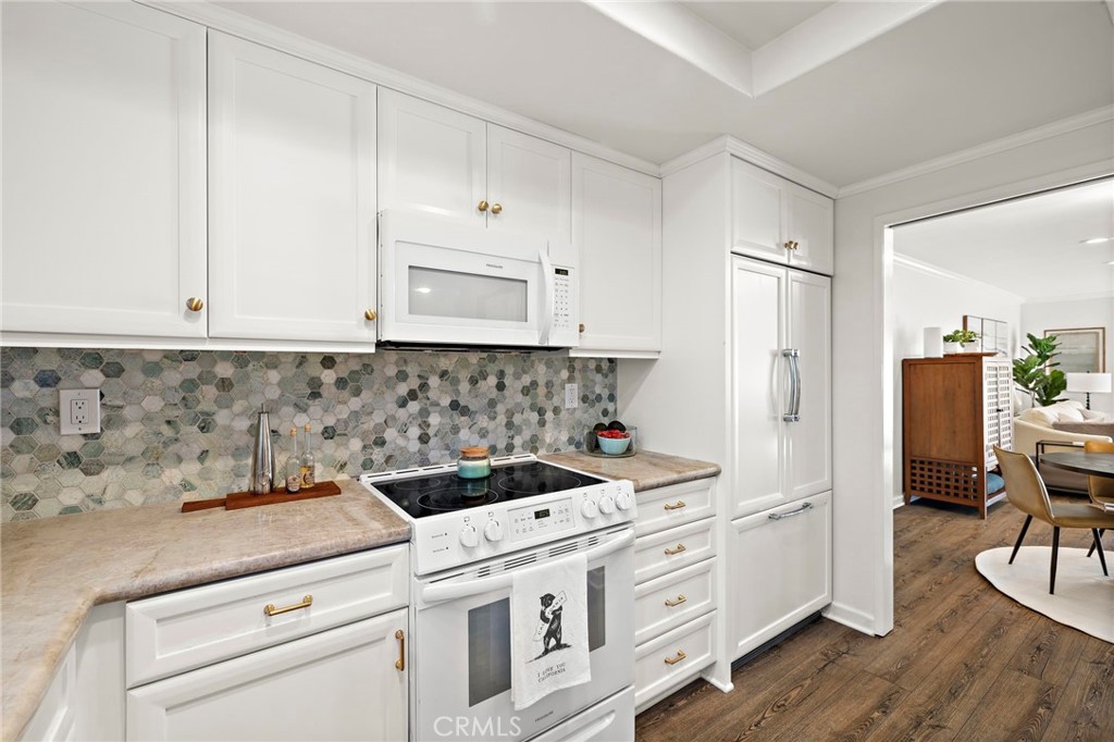 31421 East Nine Drive, Unit 79A Laguna Niguel, CA 92677 - Photo 6 of 31 a kitchen with white cabinets and white appliances
