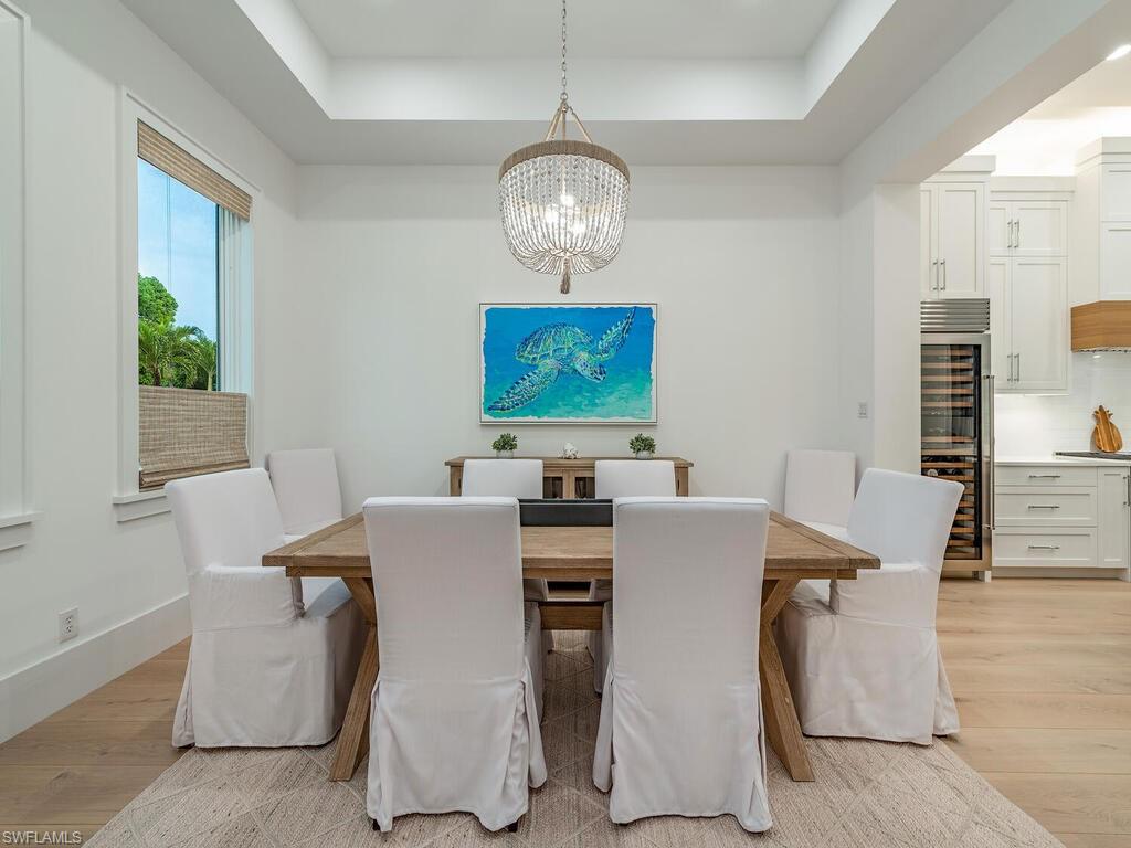 282 Bahia Point Naples, FL 34103 - Photo 12 of 38 a view of a dining room with furniture window and wooden floor