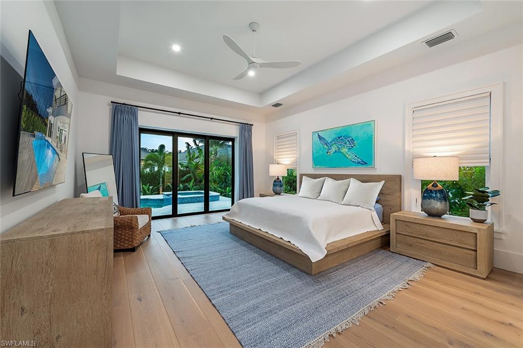 282 Bahia Point Naples, FL 34103 - Photo 17 of 38 a bedroom with a large bed and a large window