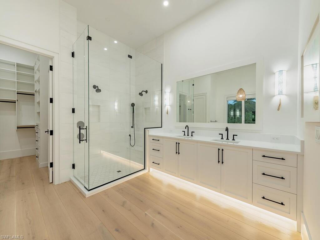 282 Bahia Point Naples, FL 34103 - Photo 19 of 38 a spacious bathroom with a granite countertop sink mirror shower and bathtub