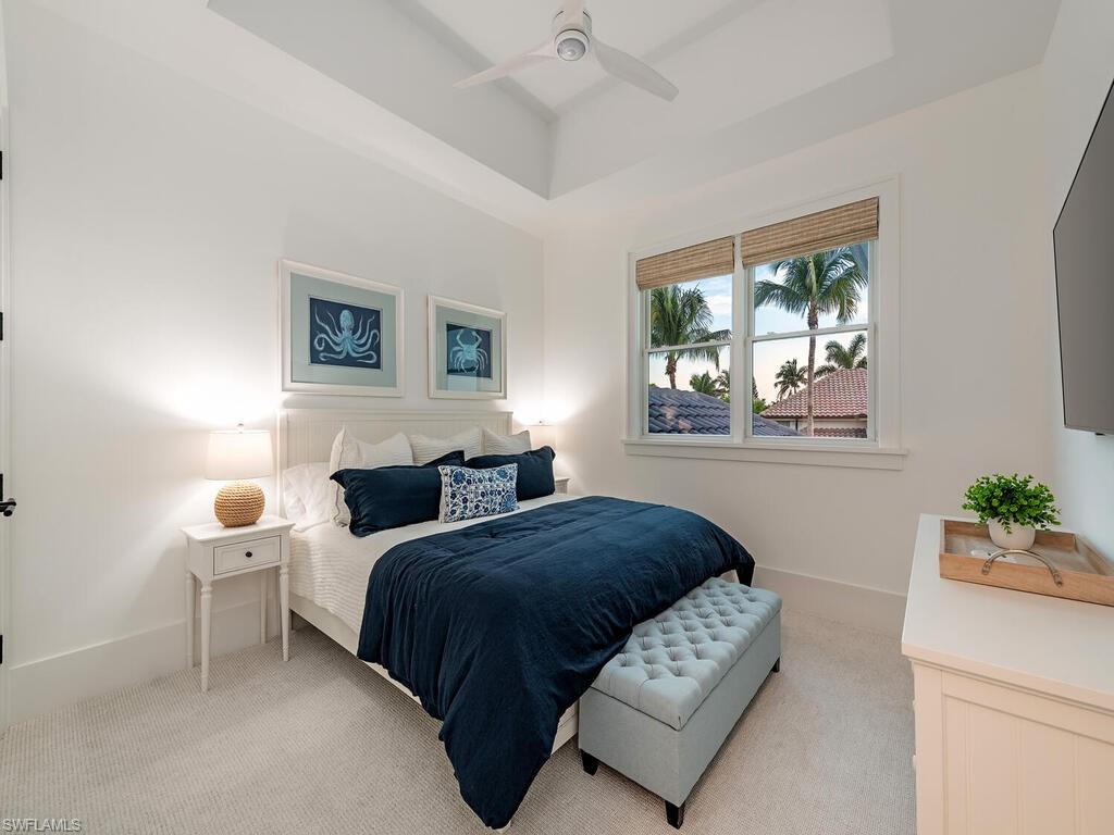 282 Bahia Point Naples, FL 34103 - Photo 22 of 38 a bedroom with a bed and a window