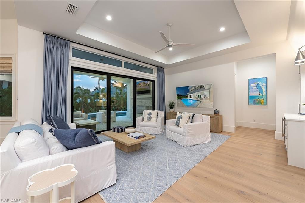 282 Bahia Point Naples, FL 34103 - Photo 10 of 38 a living room with furniture and large windows