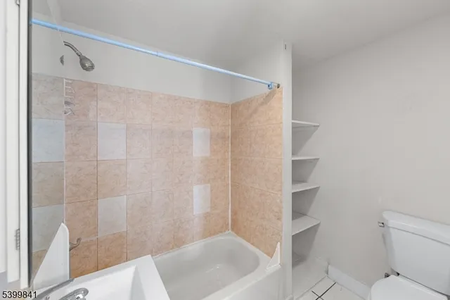 a bathroom with a shower and a toilet