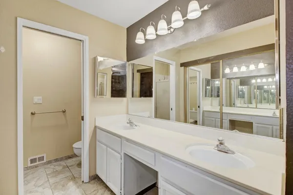 a bathroom with a sink double vanity and a mirror