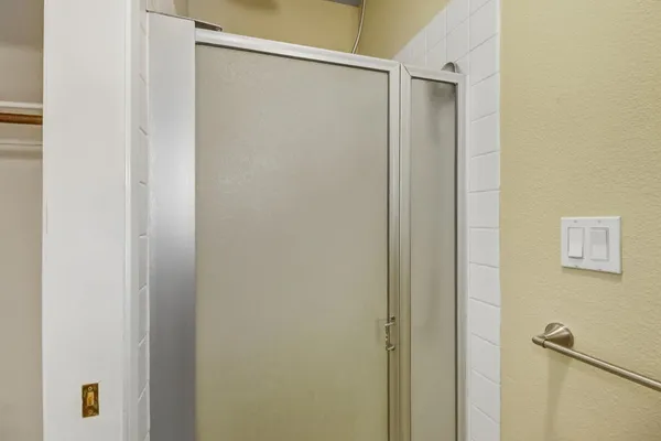 a bathroom with a shower and a shower