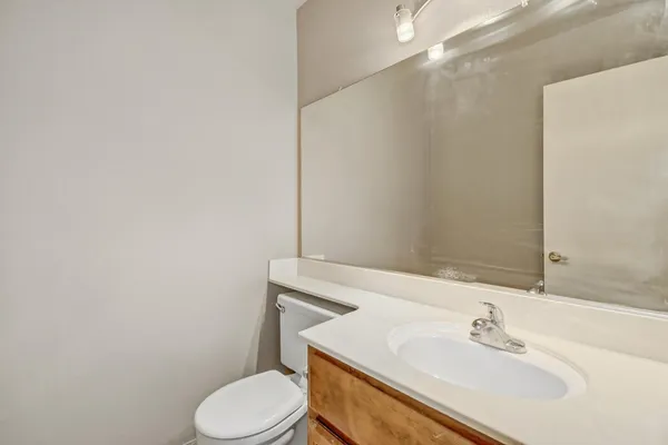a bathroom with a sink toilet and vanity